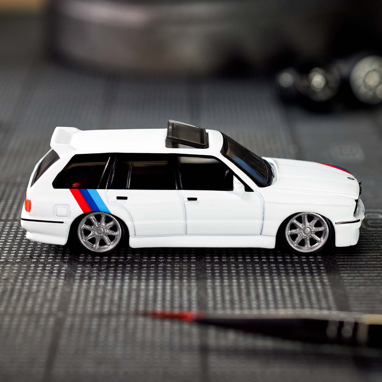 Hot Wheels Elite 64 die-cast model of the 1990 BMW 318i Touring with S54 swap and custom racing details.