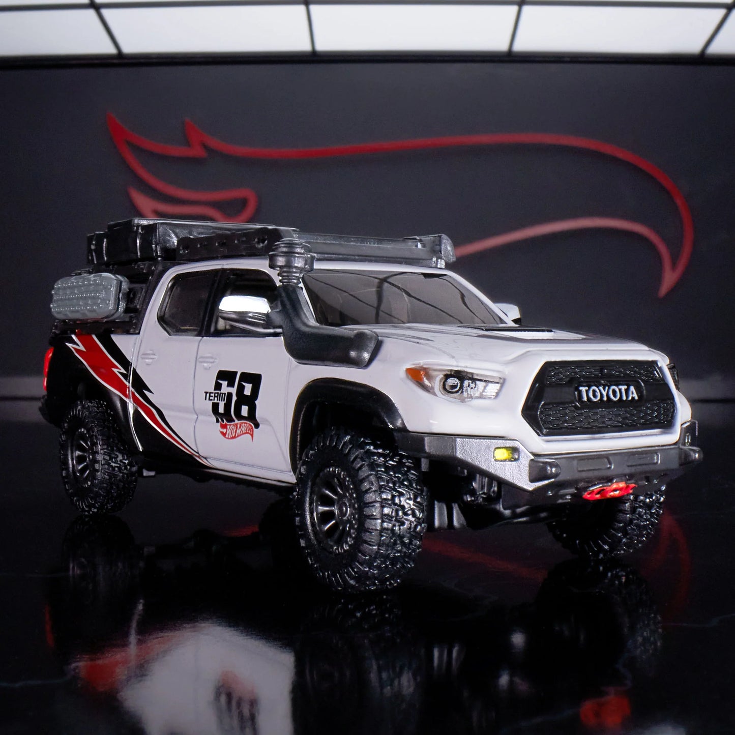 Hot Wheels Elite 64 Mod Shop die-cast 2017 Toyota Tacoma in solid gloss white with off-road accessories, model HNJ64.