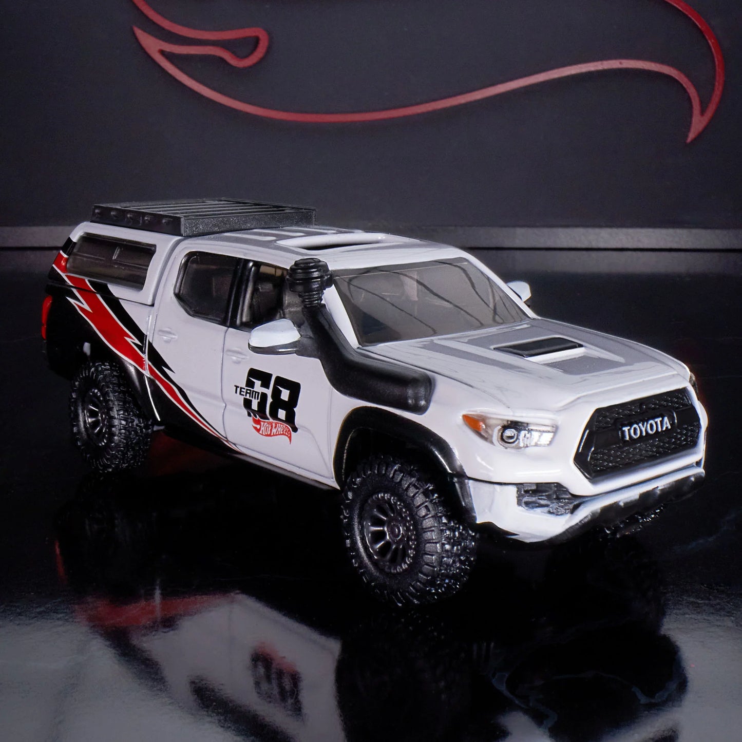Hot Wheels Elite 64 Mod Shop die-cast 2017 Toyota Tacoma in solid gloss white with off-road accessories, model HNJ64.