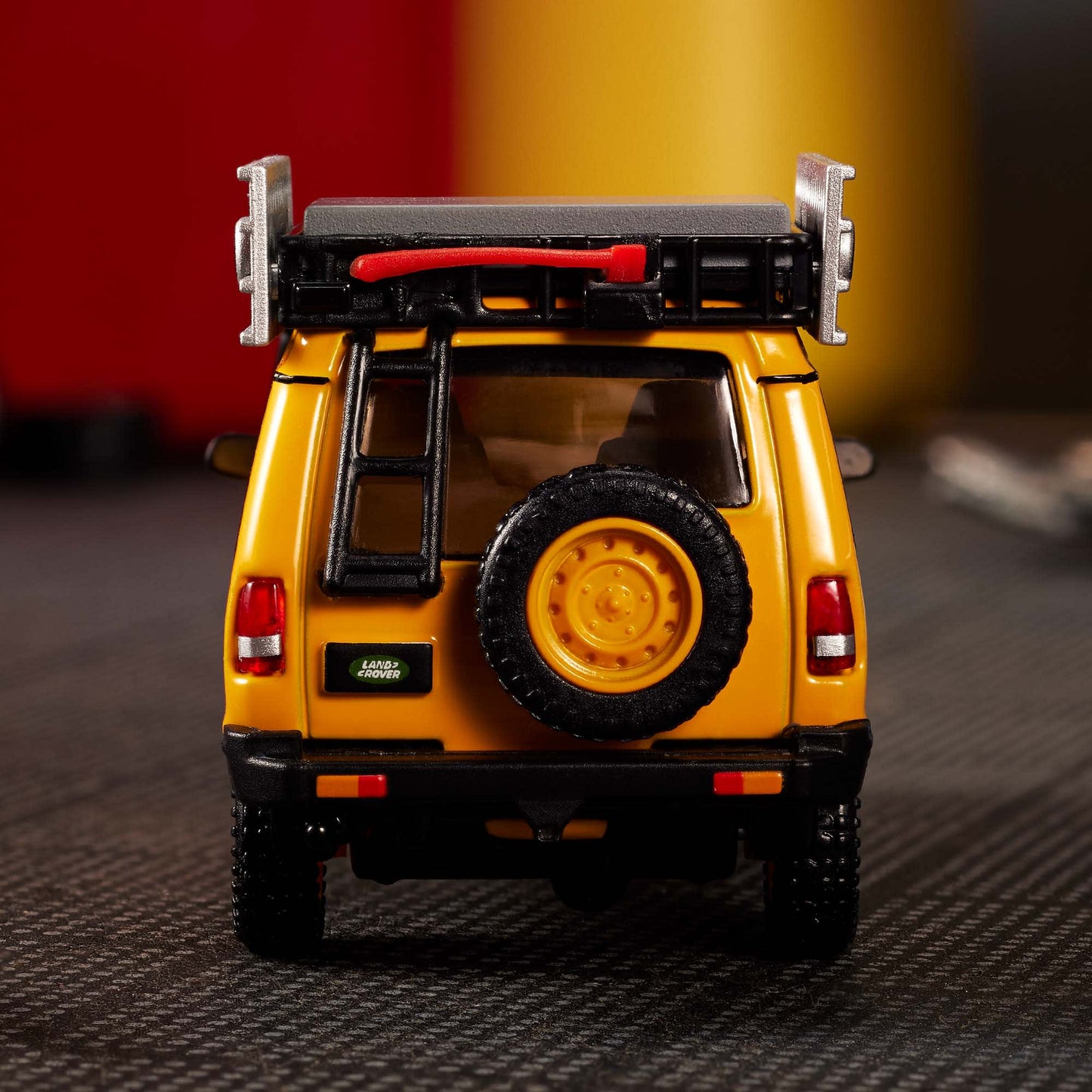 Hot Wheels Elite 64 Mod Shop 1994 Land Rover Discovery in yellow with dual wheel sets, model HNJ65