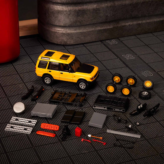 Hot Wheels Elite 64 Mod Shop 1994 Land Rover Discovery in yellow with dual wheel sets, model HNJ65