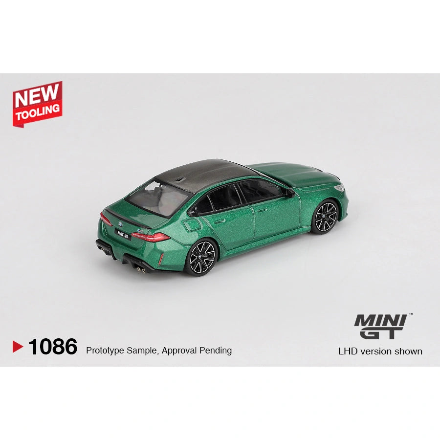 Mini GT 1:64 scale die-cast model of the BMW M5 finished in Isle of Man Green Metallic, featuring detailed M Performance styling, precision-cast body, and authentic BMW proportions