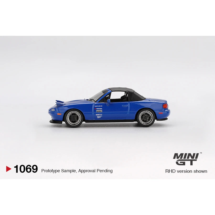 Mini GT 1:64 scale Mazda Miata MX-5 (NA) Tuned Version die-cast model in Dark Blue with LHD and blister packaging.