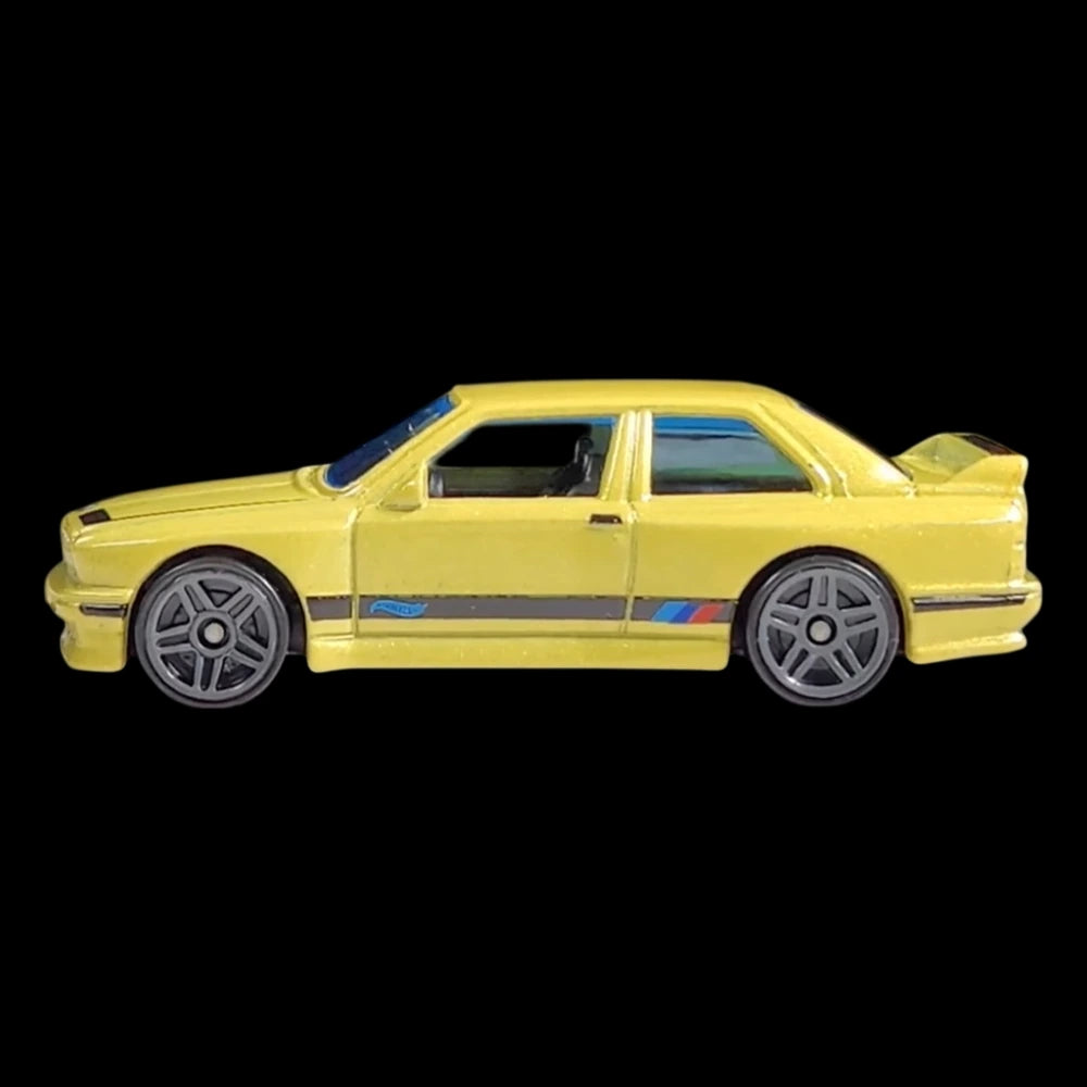 Hot Wheels 1:64 scale die-cast of the yellow '92 BMW M3 from HW: The '90s series with M stripe detailing.