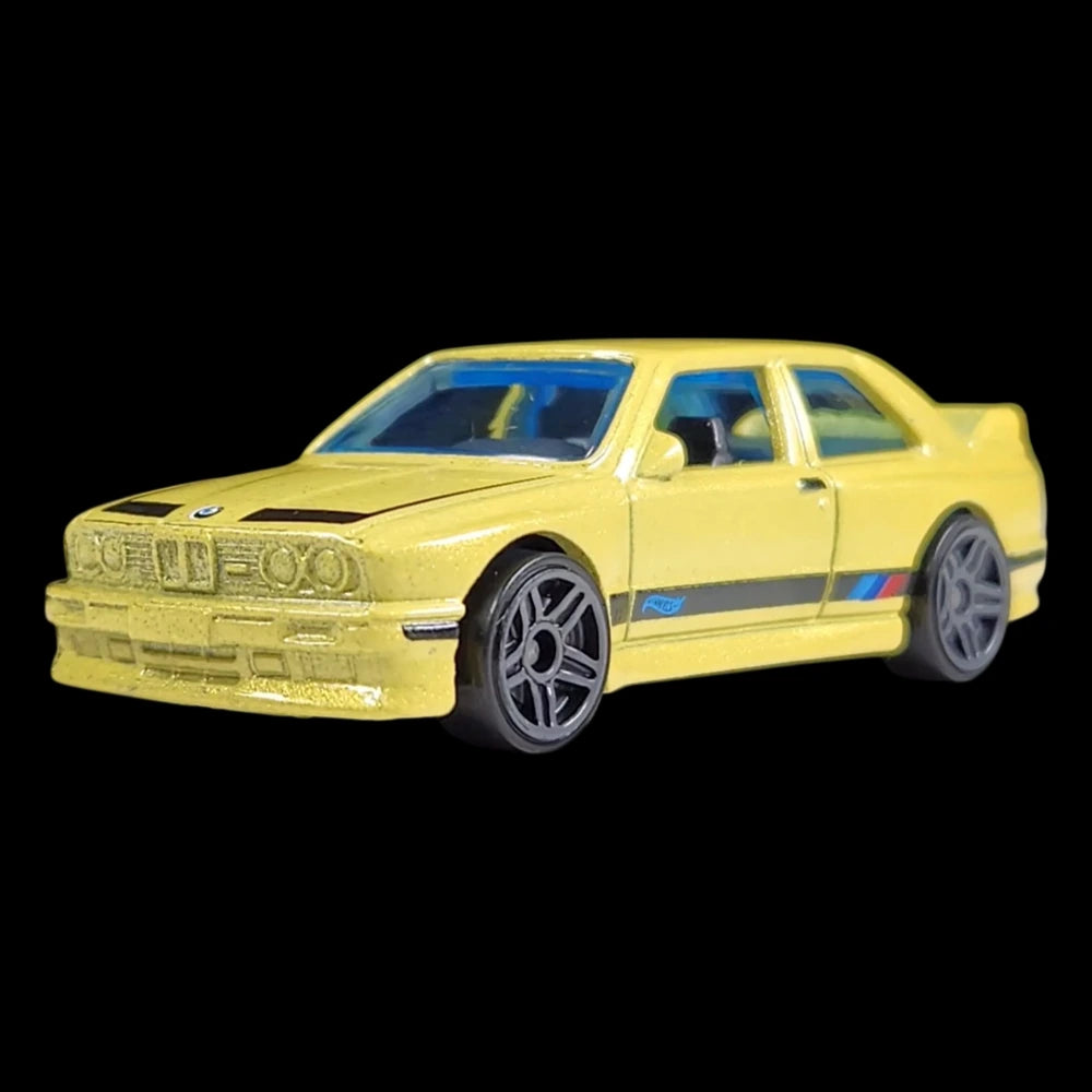 Hot Wheels 1:64 scale die-cast of the yellow '92 BMW M3 from HW: The '90s series with M stripe detailing.