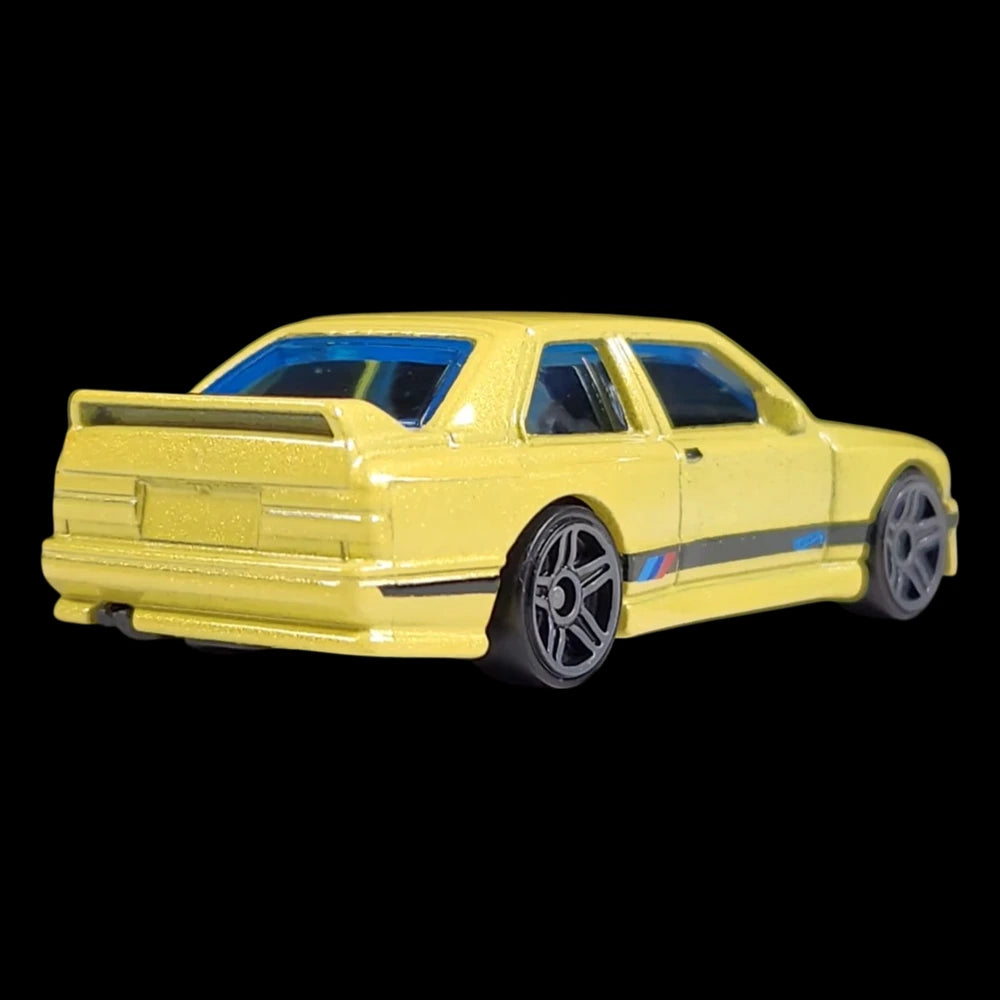 Hot Wheels 1:64 scale die-cast of the yellow '92 BMW M3 from HW: The '90s series with M stripe detailing.