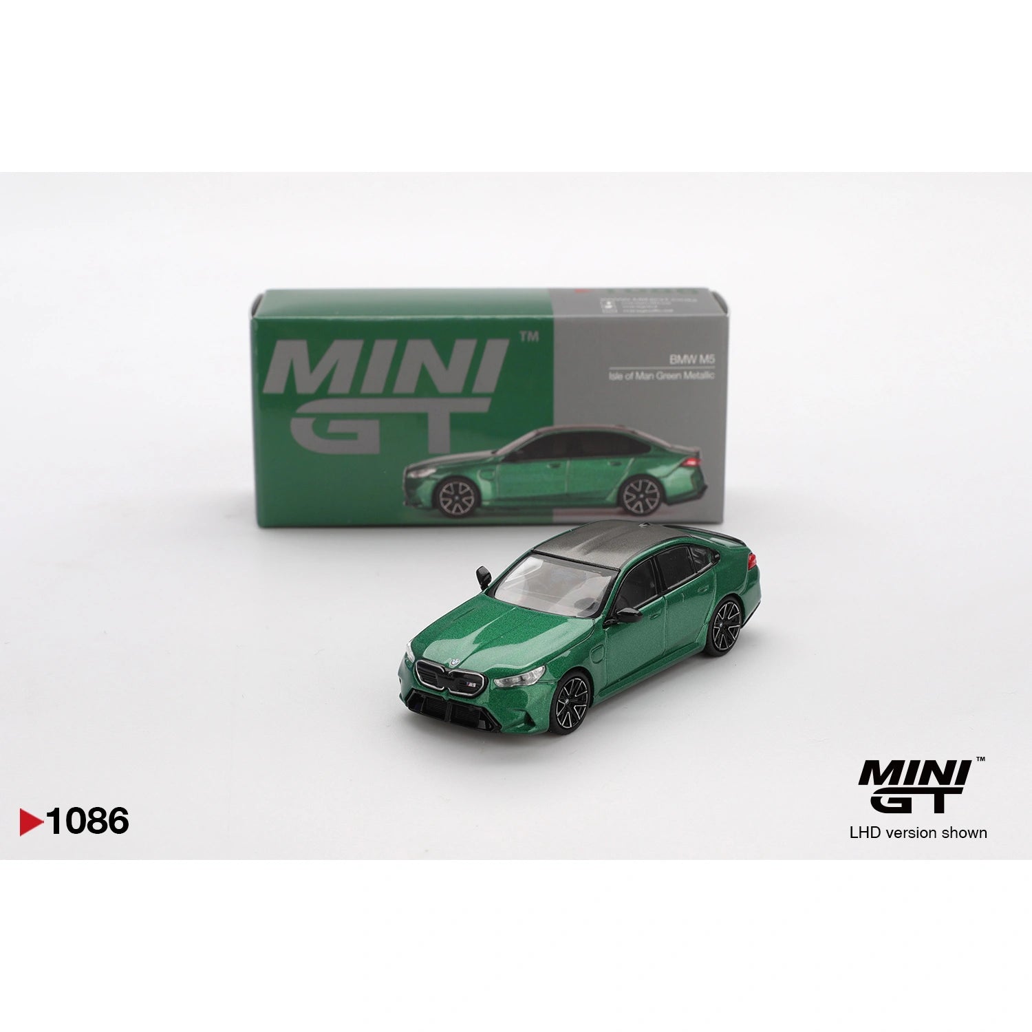 Mini GT 1:64 scale die-cast model of the BMW M5 finished in Isle of Man Green Metallic, featuring detailed M Performance styling, precision-cast body, and authentic BMW proportions