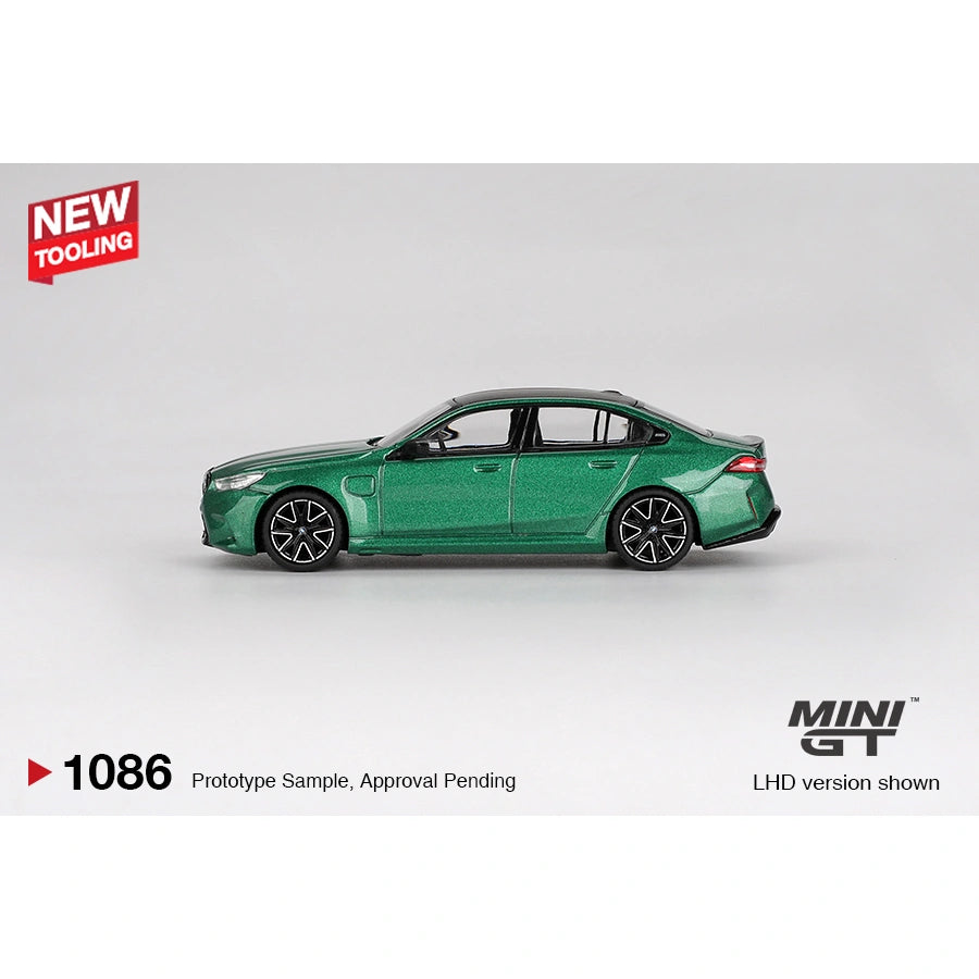 Mini GT 1:64 scale die-cast model of the BMW M5 finished in Isle of Man Green Metallic, featuring detailed M Performance styling, precision-cast body, and authentic BMW proportions