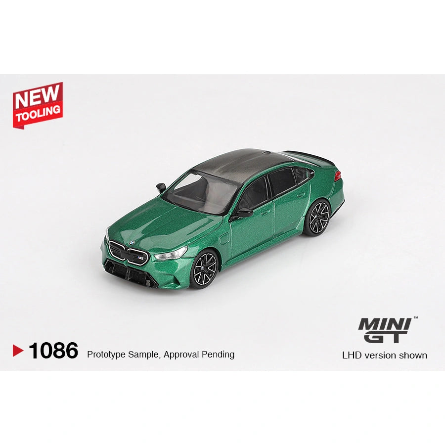 Mini GT 1:64 scale die-cast model of the BMW M5 finished in Isle of Man Green Metallic, featuring detailed M Performance styling, precision-cast body, and authentic BMW proportions