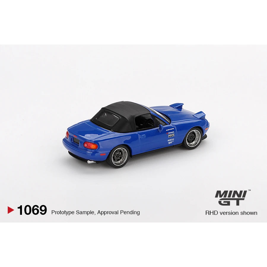 Mini GT 1:64 scale Mazda Miata MX-5 (NA) Tuned Version die-cast model in Dark Blue with LHD and blister packaging.