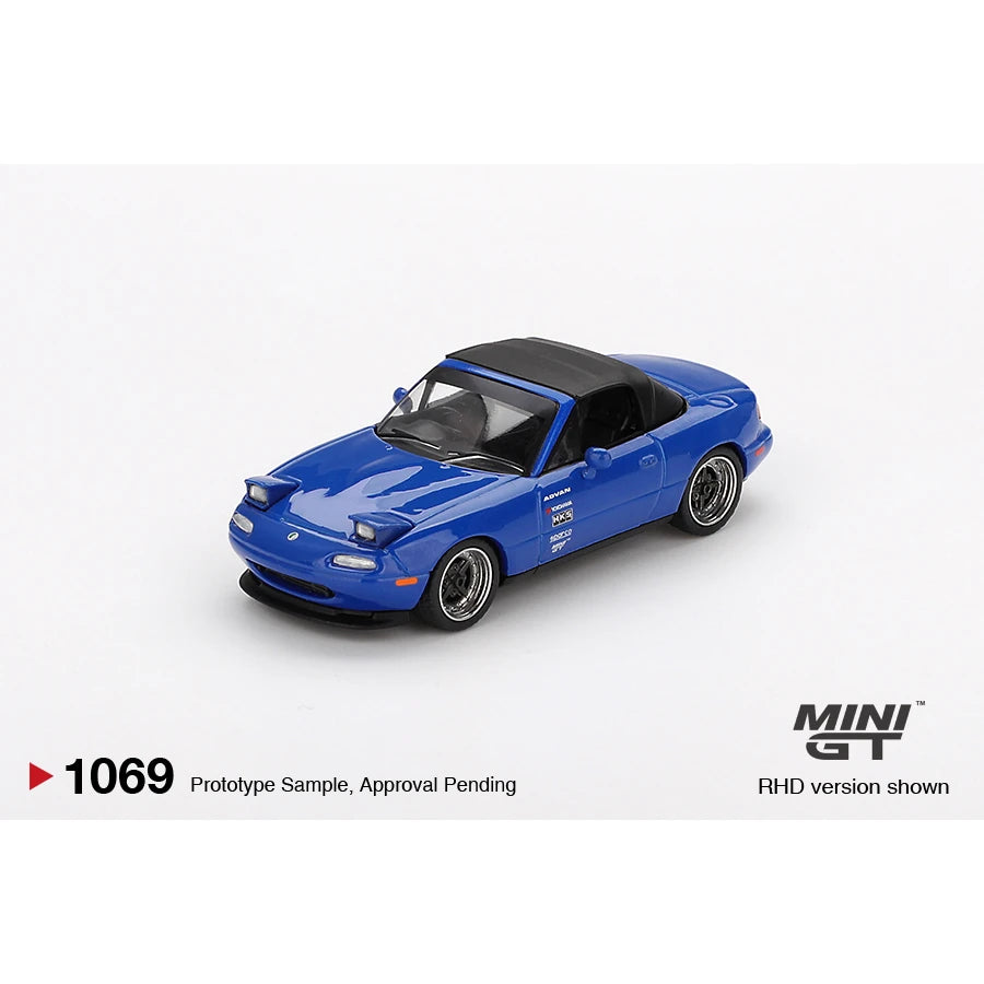 Mini GT 1:64 scale Mazda Miata MX-5 (NA) Tuned Version die-cast model in Dark Blue with LHD and blister packaging.