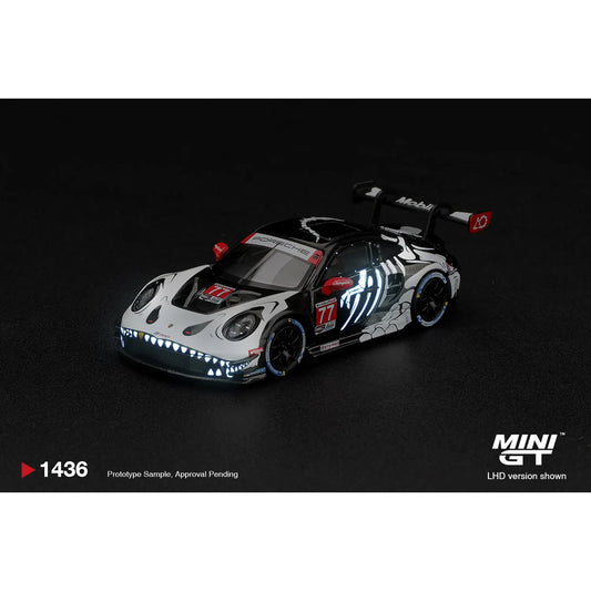 Mini GT 1:64 Porsche 911 GT3 R #77 Rexy boxed MGT01436-L with dinosaur skeleton graphics and glow-style racing livery