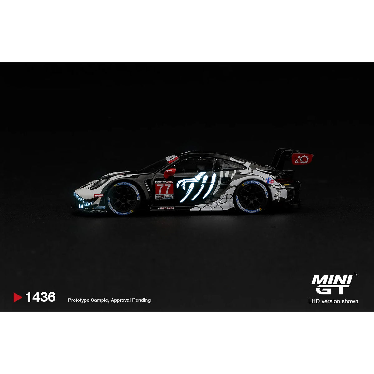 Mini GT 1:64 Porsche 911 GT3 R #77 Rexy boxed MGT01436-L with dinosaur skeleton graphics and glow-style racing livery