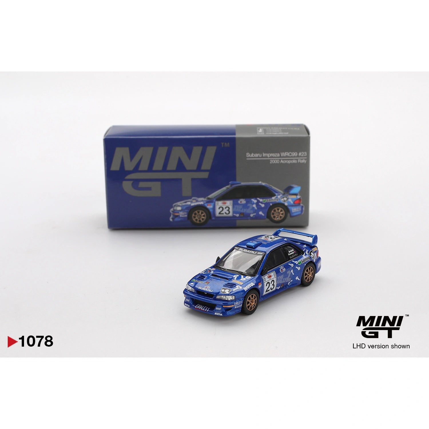 Mini GT 1:64 Subaru Impreza WRC99 #23 from the 2000 Acropolis Rally featuring rally-style livery, authentic WRC detailing, and rugged die-cast finish